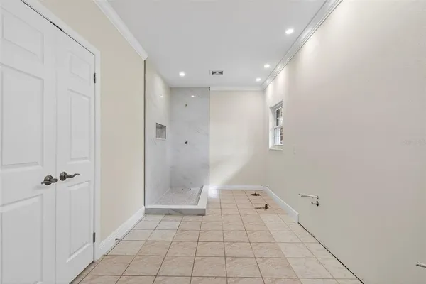 a view of an empty room with a fireplace and a window