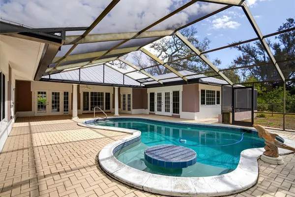 a view of a house with a yard and sitting area
