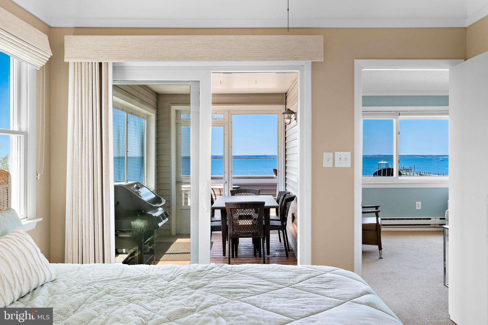 24 Joan Road Long Beach Township, NJ 08008 - Photo 21 of 55 a bedroom with a bed and glass windows