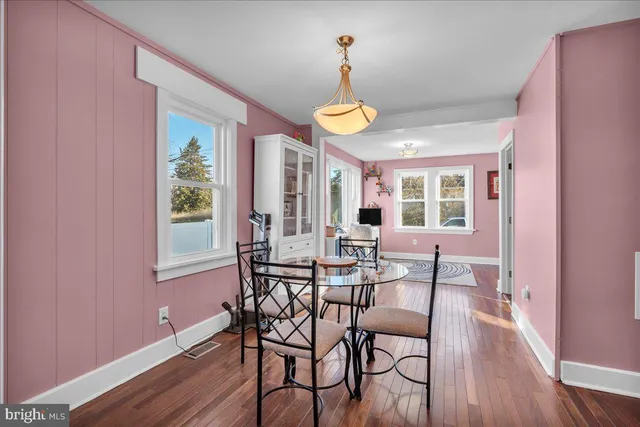 a view of a dining room with furniture and wooden floor
