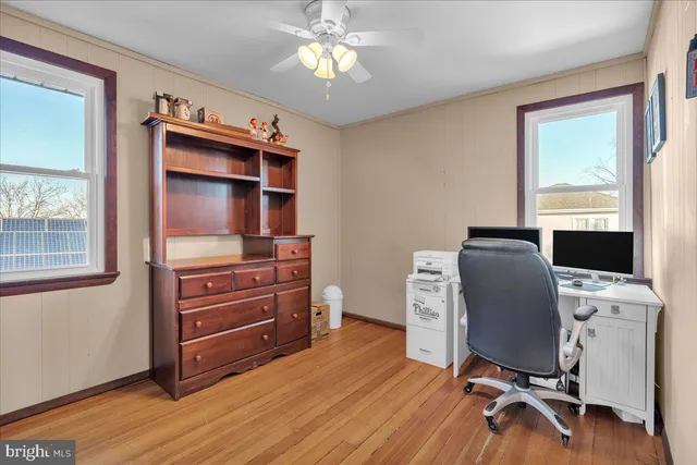 a bathroom with a granite countertop sink a bathtub and a window
