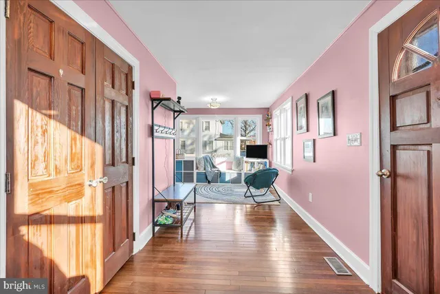 a view of a living room with a large window and wooden floor