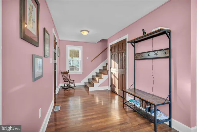a view of an entryway with wooden floor