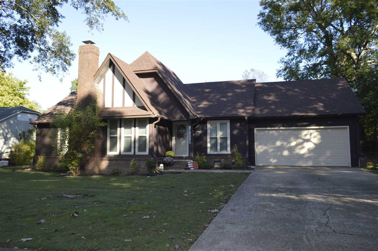 a front view of house with a garden