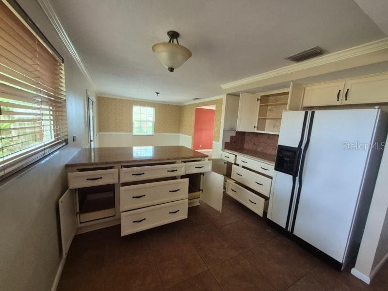 1702 Ketch Place Brandon, FL 33511 - Photo 5 of 14 a kitchen with granite countertop white cabinets and refrigerator