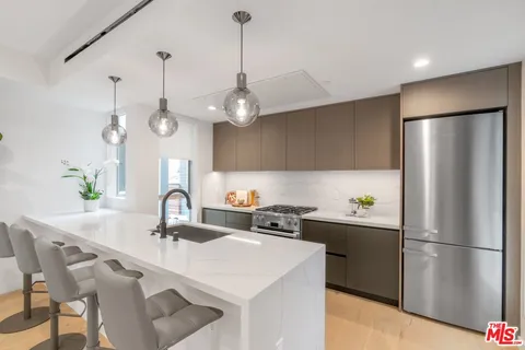a kitchen that has a sink and a stove in it