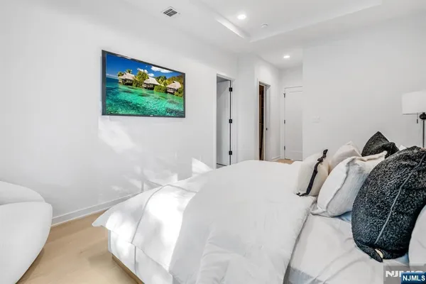 a bedroom with a bed and a flat screen tv