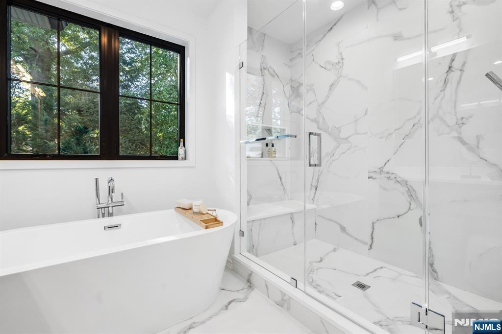 5 Fey Place Oradell, NJ 07649 - Photo 19 of 30 a white bath tub sitting next to a white sink and a shower