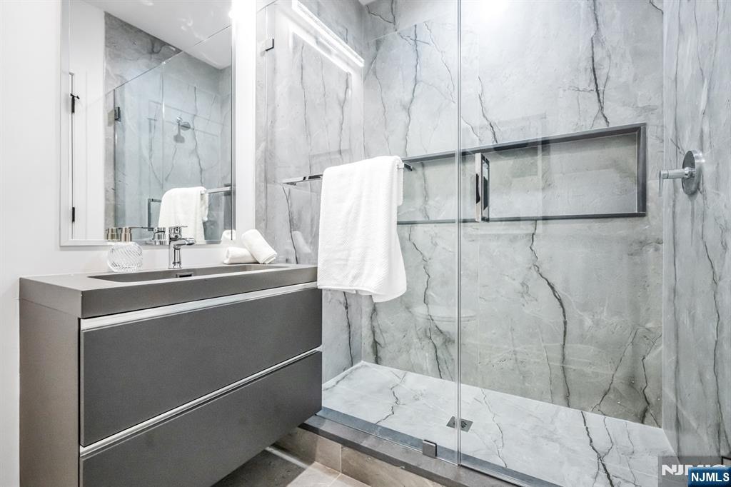 5 Fey Place Oradell, NJ 07649 - Photo 21 of 30 a bathroom with a sink and mirror