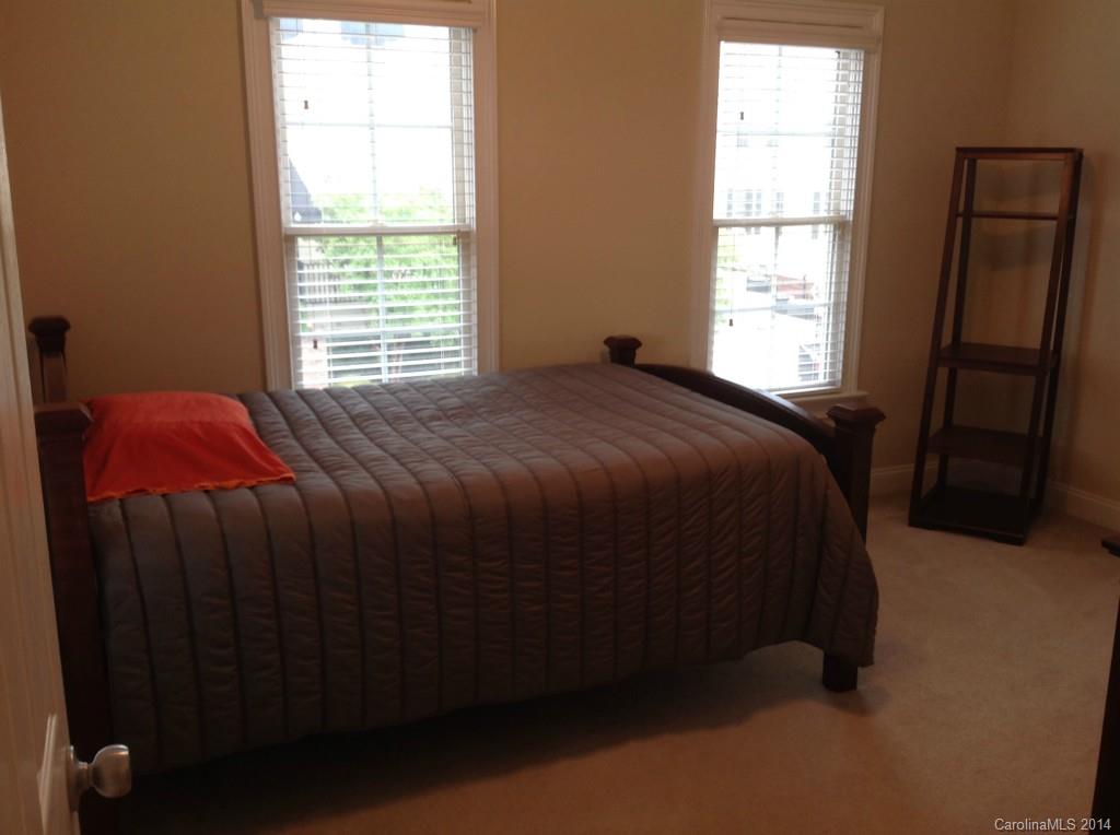 1195 Springmaid Avenue Fort Mill, SC 29708 - Photo 11 of 22 a bed sitting in a bedroom next to a window