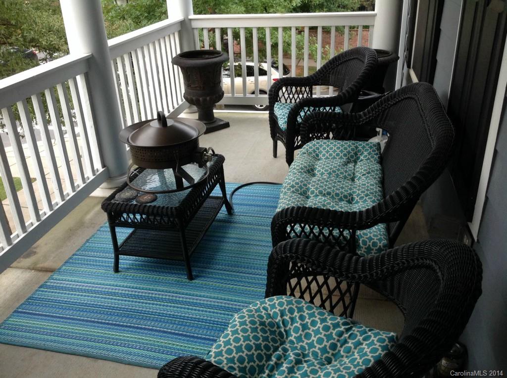 1195 Springmaid Avenue Fort Mill, SC 29708 - Photo 18 of 22 a balcony with wooden floor table and chairs