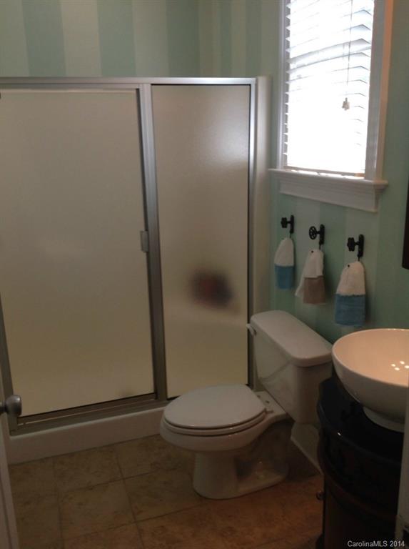 1195 Springmaid Avenue Fort Mill, SC 29708 - Photo 21 of 22 a white toilet sitting next to a bathroom sink and a shower