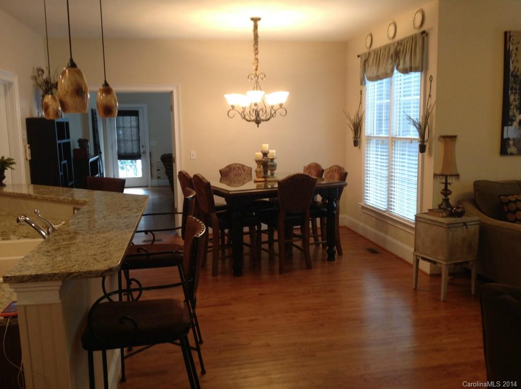 1195 Springmaid Avenue Fort Mill, SC 29708 - Photo 7 of 22 a view of a dining room with furniture window and wooden floor
