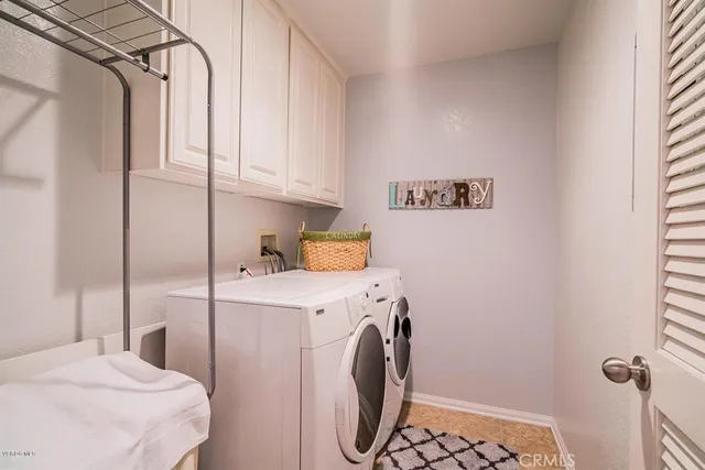 a bedroom with a bed and a washer dryer