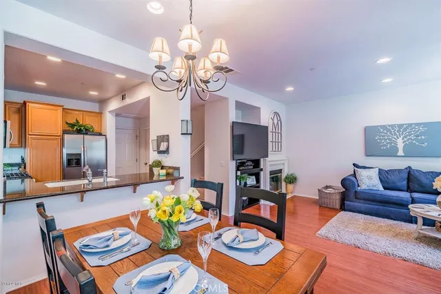 a living room with dining table furniture and a chandelier