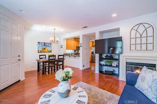 a living room with furniture dining table and wooden floors