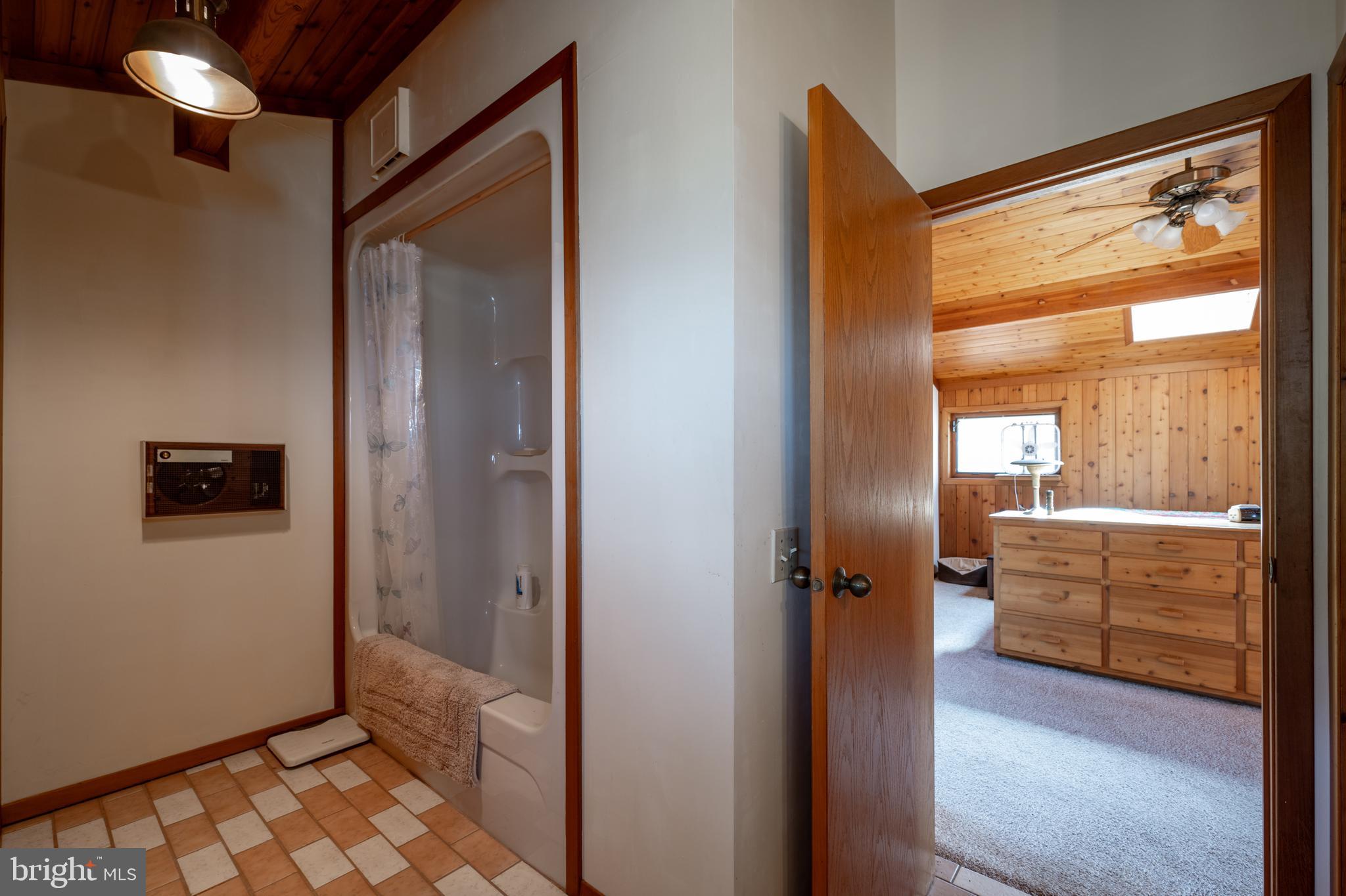 20174 Nanticoke Road Nanticoke, MD 21840 - Photo 37 of 48 a view of a hallway with bathroom and wooden floor