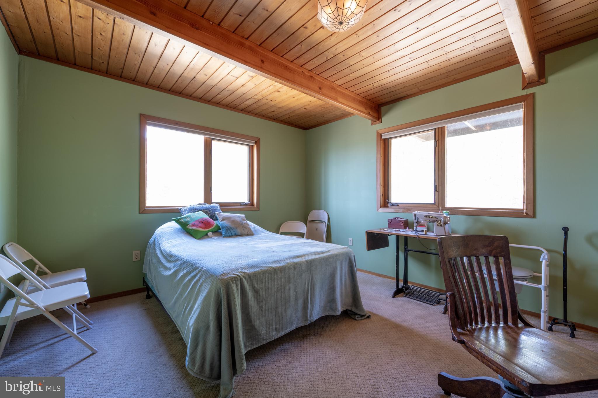 20174 Nanticoke Road Nanticoke, MD 21840 - Photo 42 of 48 a bedroom with furniture and a window