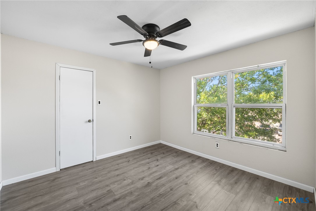 8010 Chestnut Gate Lane Converse, TX 78109 - Photo 12 of 35 wooden floor in an empty room with a window