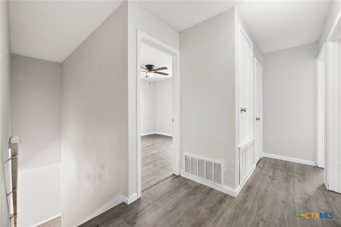 8010 Chestnut Gate Lane Converse, TX 78109 - Photo 13 of 35 a view of a hallway with wooden floor