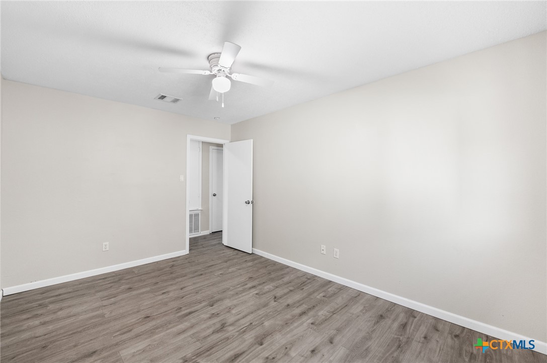 8010 Chestnut Gate Lane Converse, TX 78109 - Photo 23 of 35 a view of an empty room with wooden floor