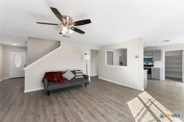 a living room with furniture and wooden floor