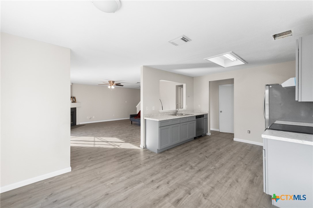 8010 Chestnut Gate Lane Converse, TX 78109 - Photo 7 of 35 a view of a kitchen with a sink and dishwasher in white cabinet