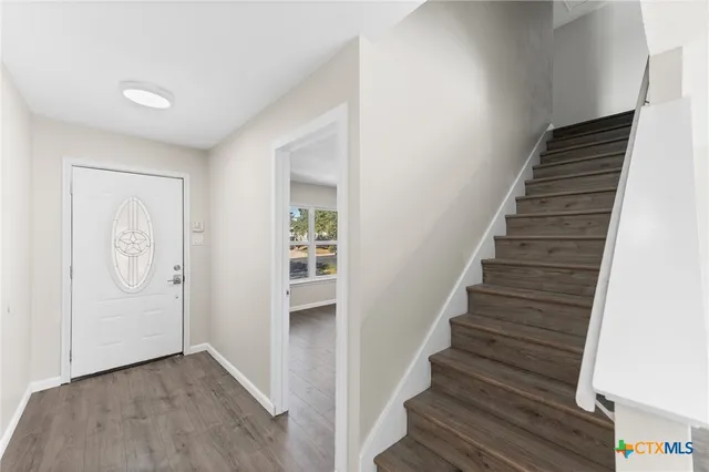 a view of an entryway with wooden floor