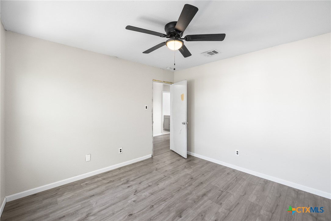 8010 Chestnut Gate Lane Converse, TX 78109 - Photo 10 of 35 a view of a room with wooden floor and a ceiling fan