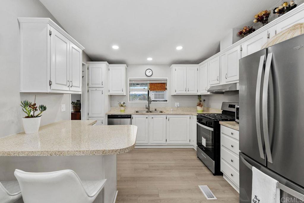 530 West Devonshire Avenue, Unit 84 Hemet, CA 92543 - Photo 1 of 36 a kitchen with white cabinets and stainless steel appliances