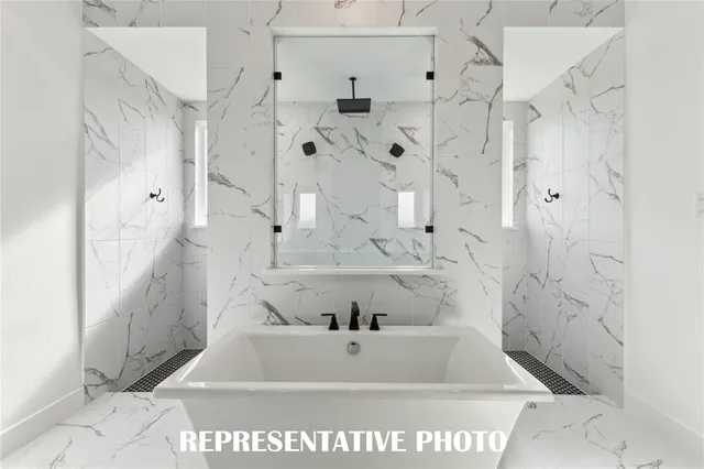 a spacious bathroom with a bathtub and double sink