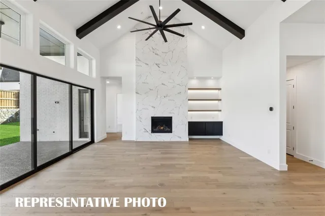 a view of kitchen with stainless steel appliances kitchen island a sink dishwasher a stove and a refrigerator with wooden floor