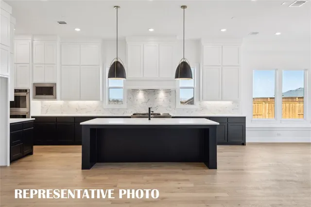 a kitchen with a sink a counter top space and a fireplace