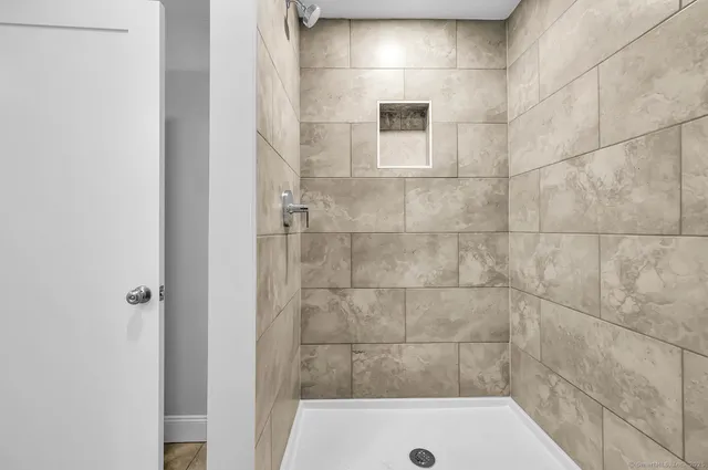 a bathroom with a bathtub and shower