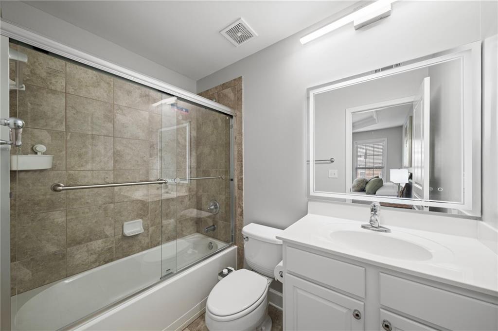 2872 Overlook Way Northeast Atlanta, GA 30324 - Photo 29 of 47 a bathroom with a sink a toilet and a mirror