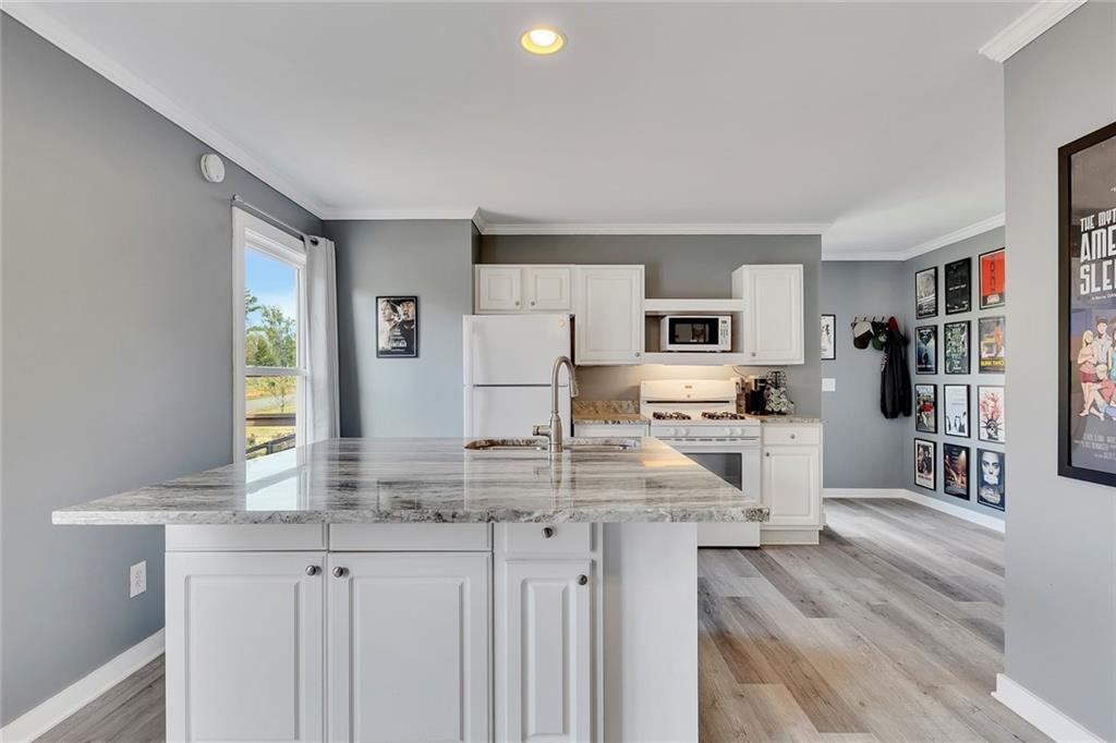 801 Town Creek Church Road Talking Rock, GA 30175 - Photo 30 of 58 a kitchen with kitchen island granite countertop a sink cabinets and stainless steel appliances
