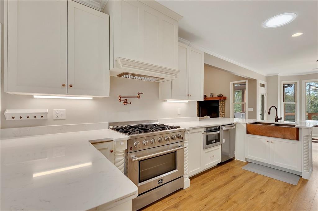 801 Town Creek Church Road Talking Rock, GA 30175 - Photo 7 of 58 a kitchen with white cabinets and appliances
