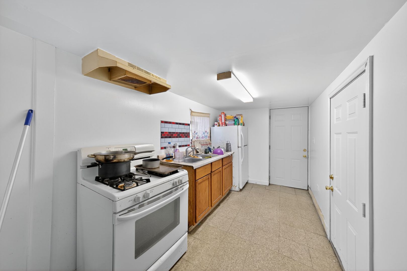 6541 South Carpenter Street Chicago, IL 60621 - Photo 14 of 27 a kitchen with a stove and a sink