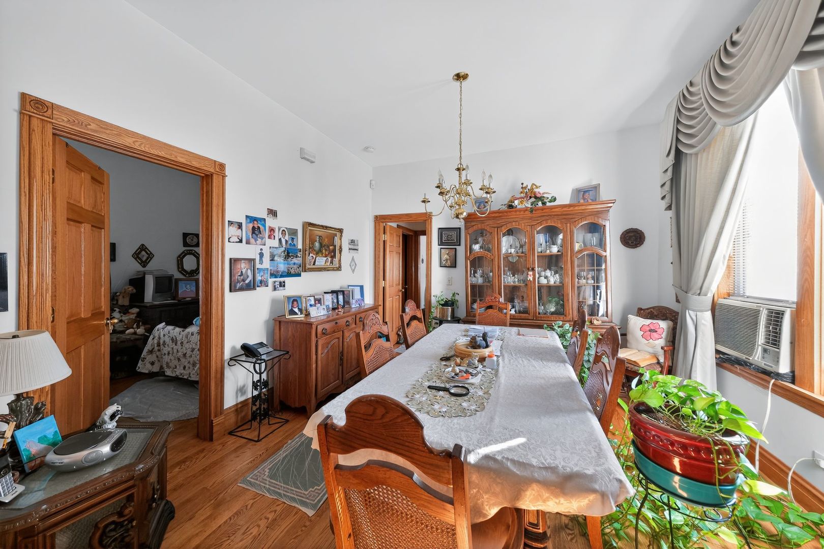 6541 South Carpenter Street Chicago, IL 60621 - Photo 15 of 27 a view of a dining room and livingroom with furniture wooden floor chandelier