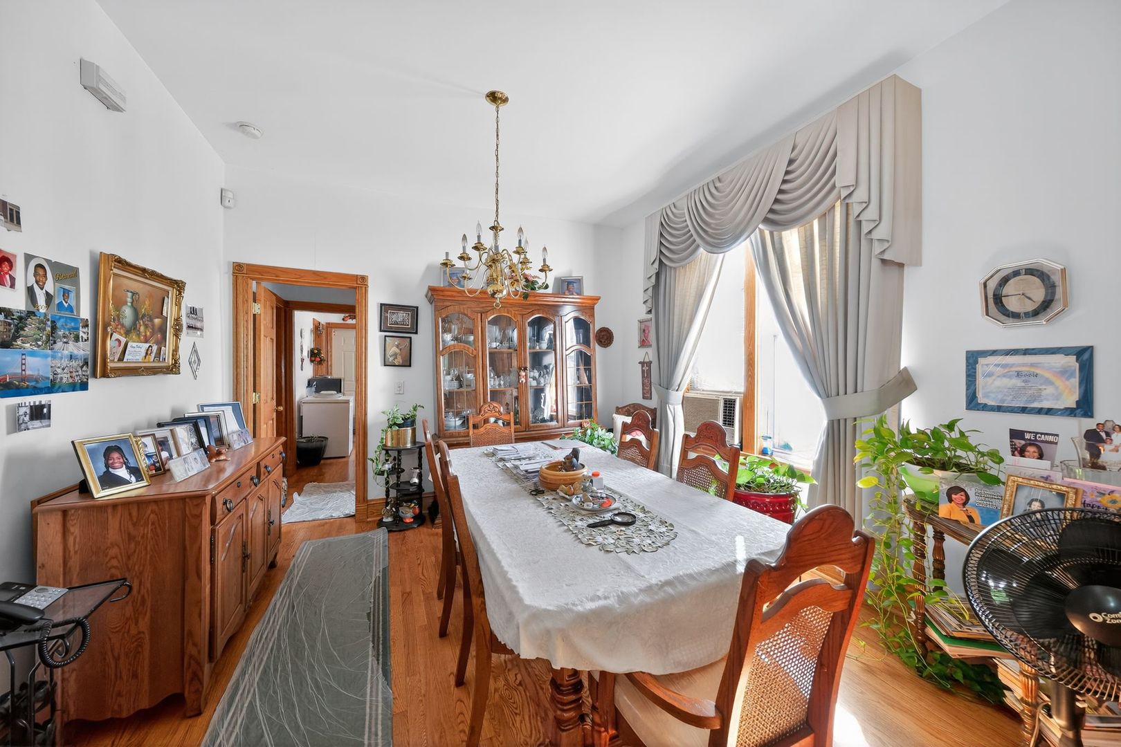 6541 South Carpenter Street Chicago, IL 60621 - Photo 16 of 27 a view of a dining room and livingroom with furniture wooden floor a chandelier