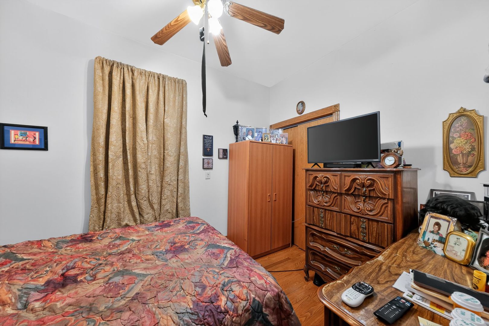 6541 South Carpenter Street Chicago, IL 60621 - Photo 22 of 27 a bedroom with a bed and a flat tv screen on a dresser