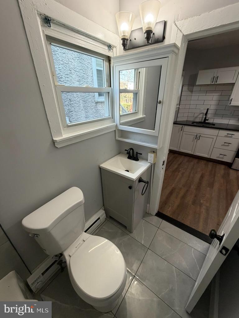 1410 Huddell Avenue Marcus Hook, PA 19061 - Photo 11 of 29 a bathroom with a toilet a sink and a mirror