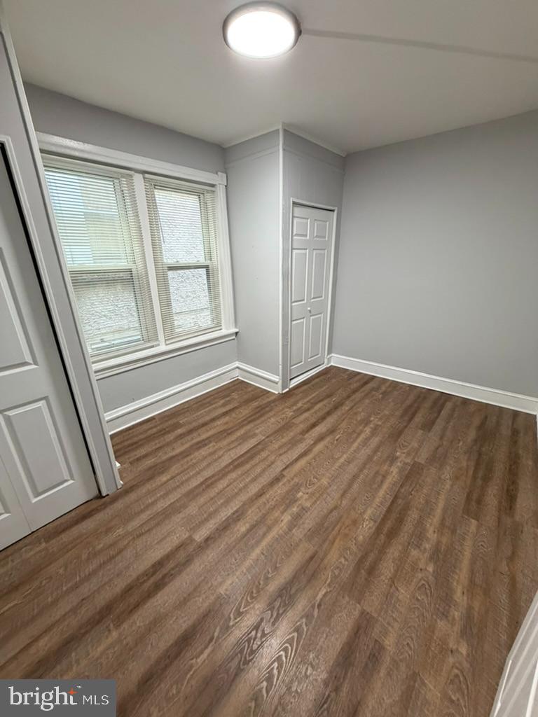 1410 Huddell Avenue Marcus Hook, PA 19061 - Photo 14 of 29 a view of an empty room with wooden floor and a window