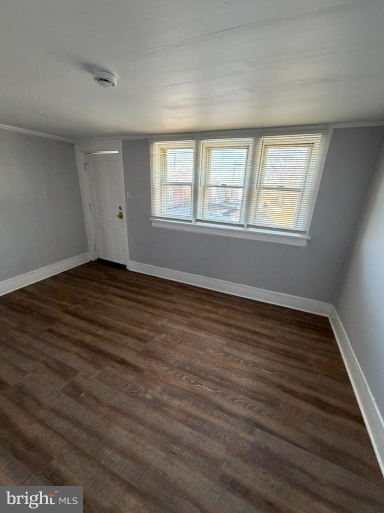1410 Huddell Avenue Marcus Hook, PA 19061 - Photo 17 of 29 a view of an empty room with wooden floor and a window