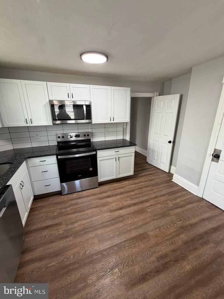 1410 Huddell Avenue Marcus Hook, PA 19061 - Photo 21 of 29 a kitchen with stainless steel appliances kitchen island granite countertop a sink stove and cabinets