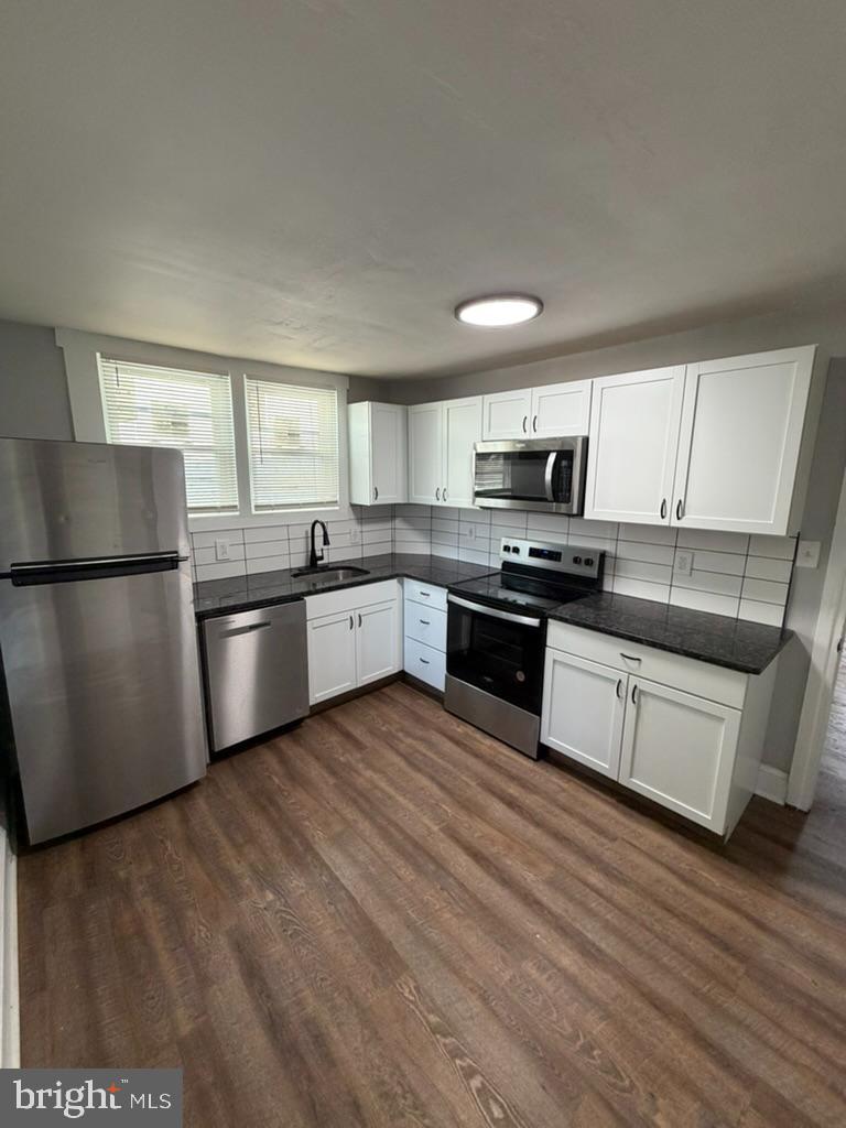 1410 Huddell Avenue Marcus Hook, PA 19061 - Photo 22 of 29 a kitchen with granite countertop a refrigerator and a stove top oven
