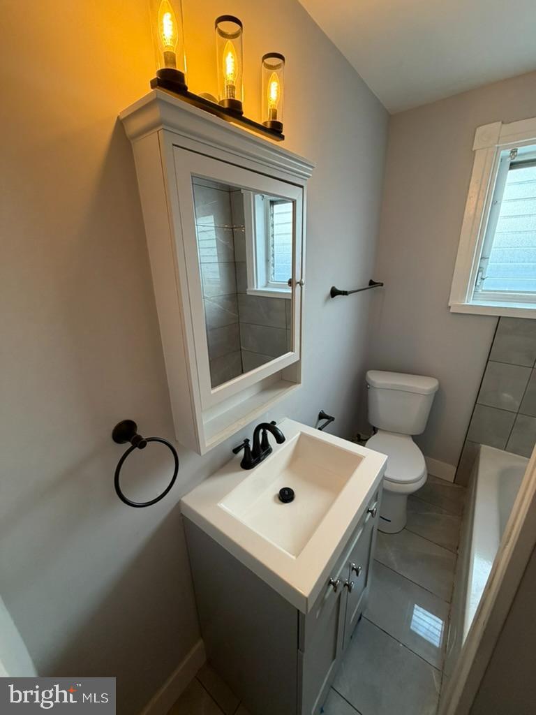 1410 Huddell Avenue Marcus Hook, PA 19061 - Photo 25 of 29 a bathroom with a sink toilet and vanity