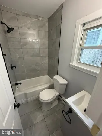 a bathroom with a sink a toilet and a bathtub