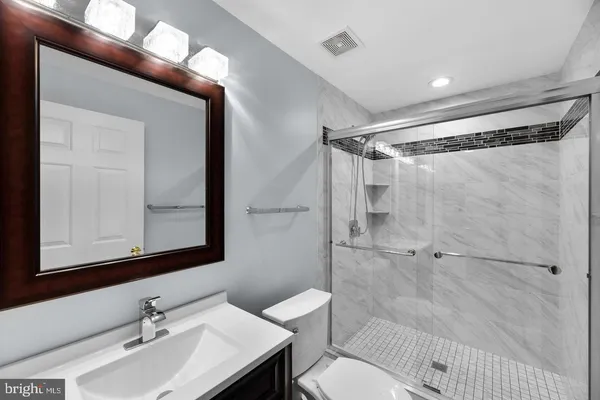 a bathroom with a glass door shower