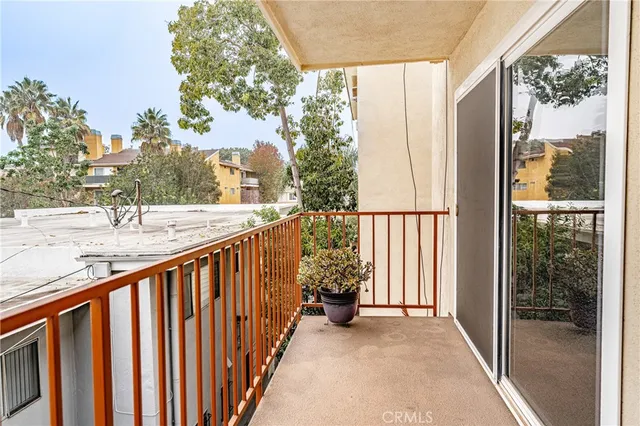 a view of a blue house with large windows